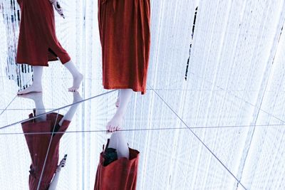 Low section of people standing on tiled floor