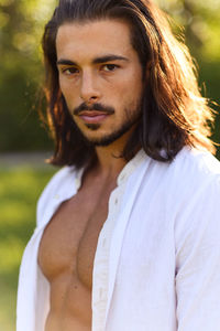 Portrait of man standing against plants in park