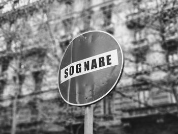 Close-up of road sign against trees