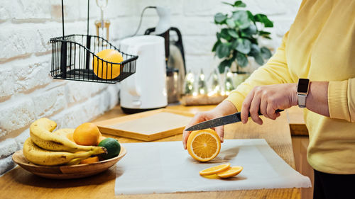 How to dry orange slices for holiday decor. process of drying orange slices in the oven. woman