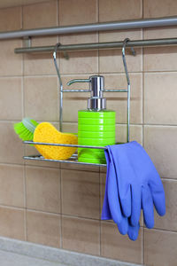 Close-up of gloves and sponge on rack