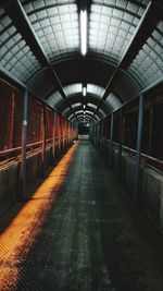 Illuminated empty footbridge at night