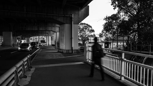 Man walking on bridge