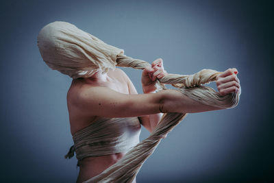 Low angle view of woman dancing against white background