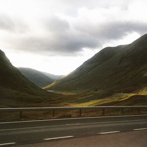 Scenic view of mountains against cloudy sky