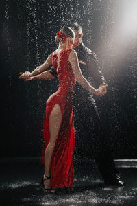 A couple of dancers on a black background in a studio in the aqua zone