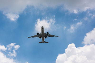 Low angle view of airplane flying in sky