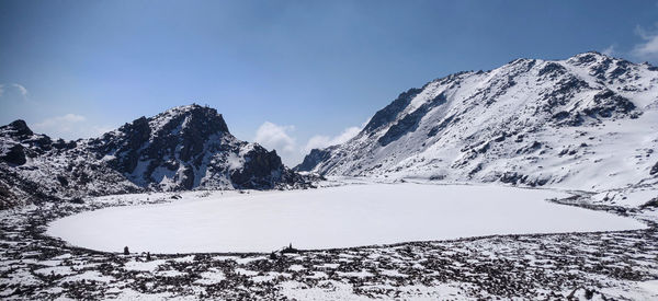 Scenic view of snow covered mountains against sky