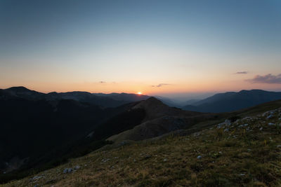 Scenic view of mountains against sky during sunset