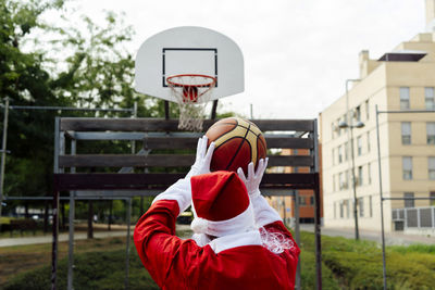 Santa claus throwing a triple with his basketball