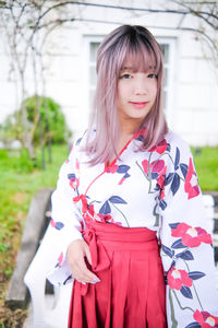 Portrait of young woman standing outdoors