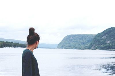 Side view of woman looking towards lake at quebec