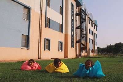 People relaxing in front of building