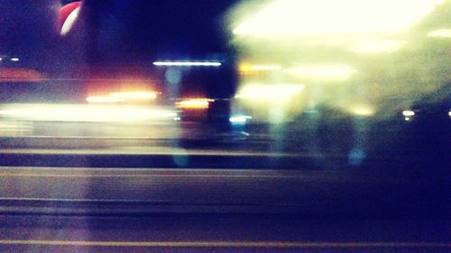 Blurred motion of car on road at night