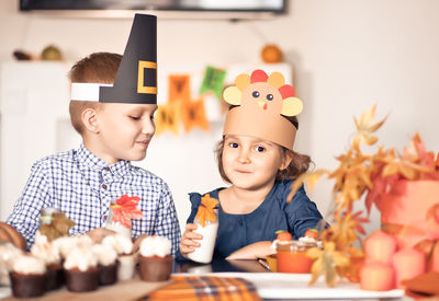 Portrait of sibling wearing costume at home