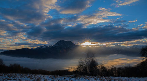 Scenic view of snow mountains against sky during sunset