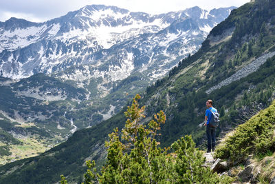 Rear view of man standing on mountain