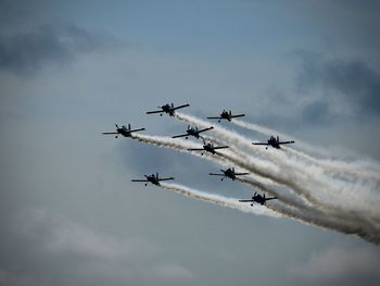 Low angle view of airshow against sky