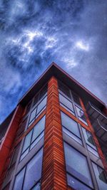 Low angle view of modern building against cloudy sky