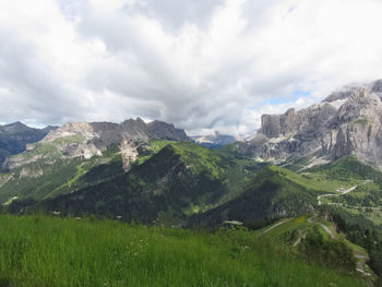 Scenic view of mountains against cloudy sky