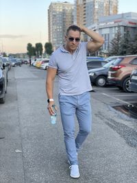 Young man standing on street in city