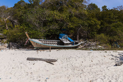 A broken boat stands on the sand. boat by the sea. fishing boat washed ashore