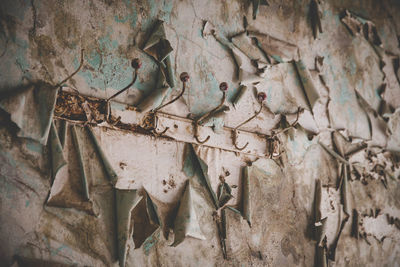 Old hanger in an abandoned building with washed up dusty wallpaper