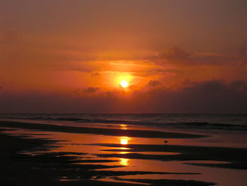 Scenic view of sea against orange sky