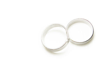 High angle view of wedding rings on white background