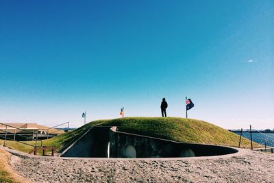 Silhouette of woman against clear blue sky