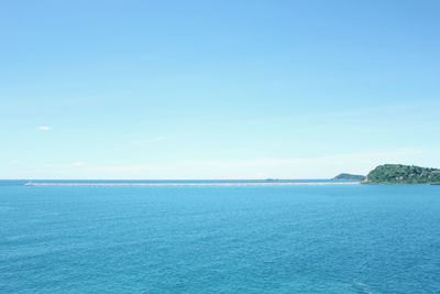 Scenic view of sea against clear blue sky