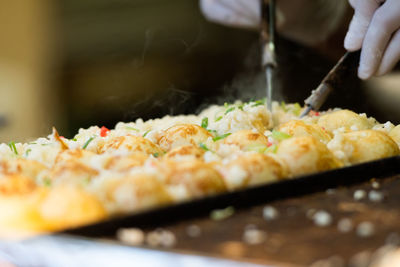 Close-up of person preparing food in restaurant