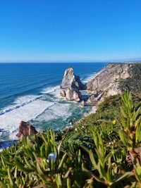 Scenic view of sea against clear blue sky