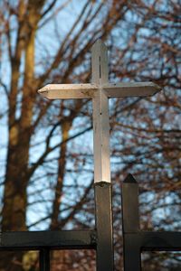 Low angle view of cross against sky