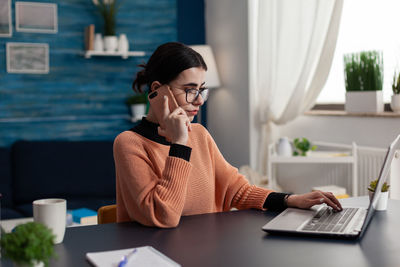 Businesswoman talking on phone in office