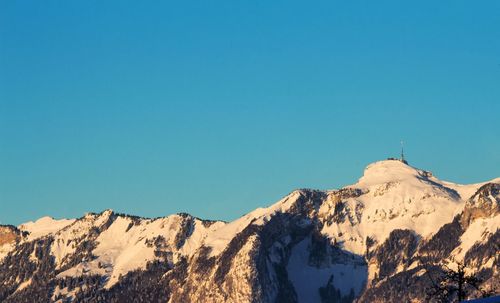 Scenic view of mountains against clear blue sky