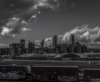 View of cityscape against cloudy sky