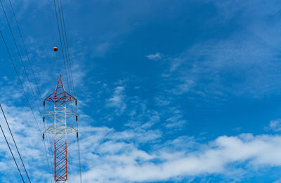 High voltage electric tower and transmission lines. electricity pylon with blue sky and white cloud.