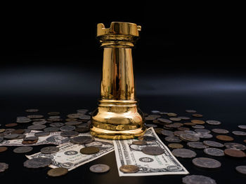 Close-up of coins on table against black background
