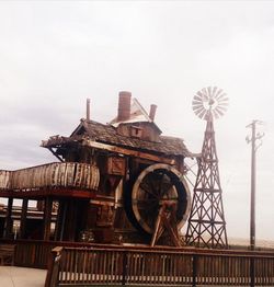 Low angle view of traditional windmill against sky