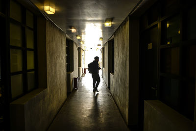 Rear view of people walking on corridor