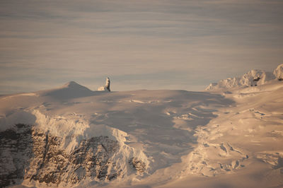 Scenic view of snowcapped mountains against sky during sunset