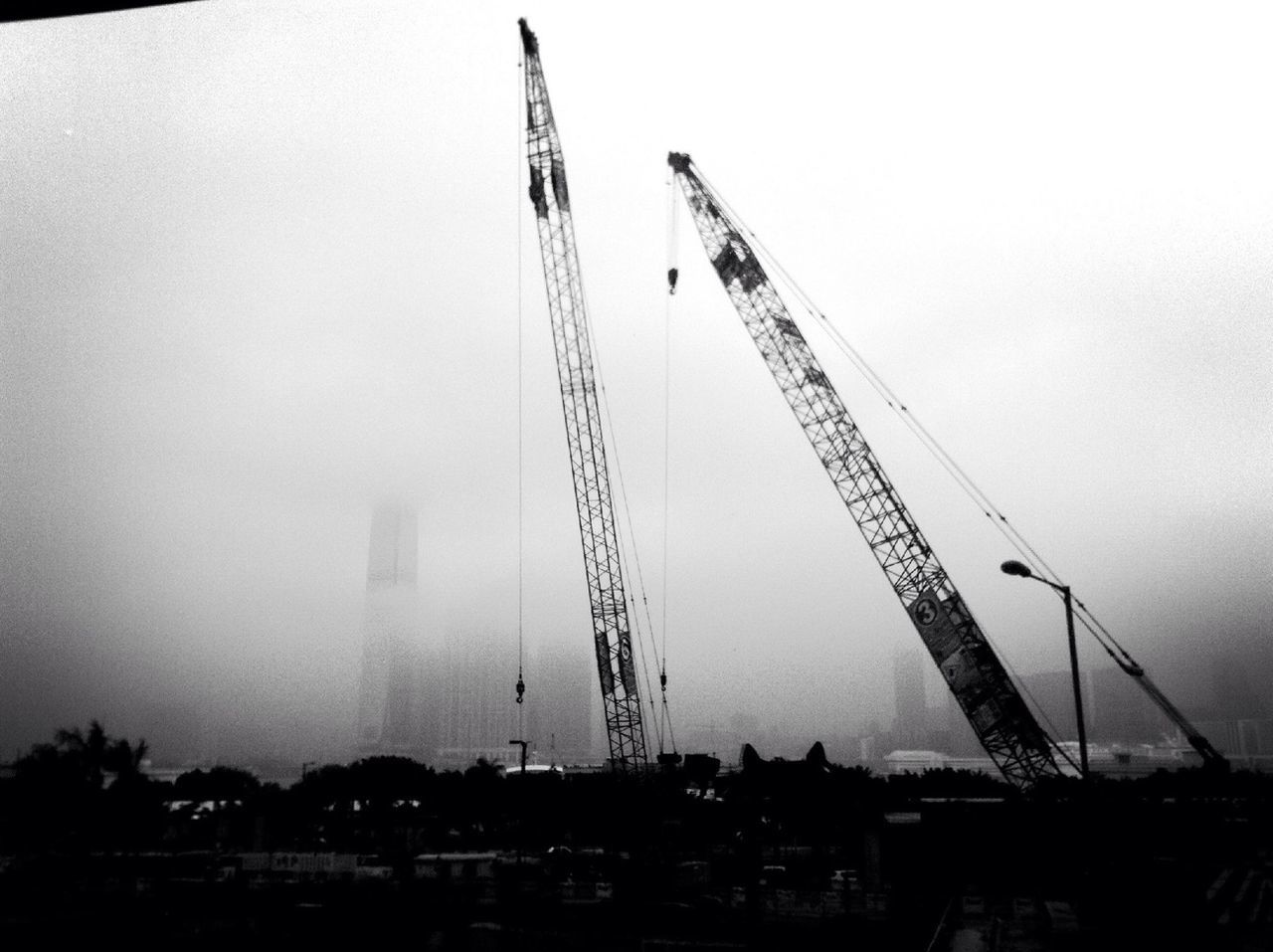 crane - construction machinery, construction site, development, clear sky, crane, built structure, construction, architecture, building exterior, tall - high, industry, copy space, sky, low angle view, construction industry, outdoors, no people, day, incomplete, dusk