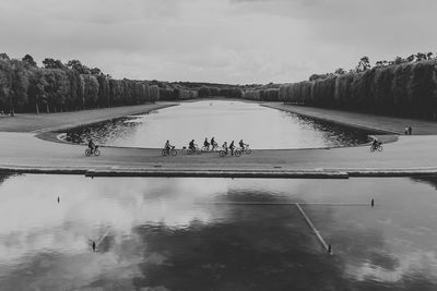 People on shore against sky