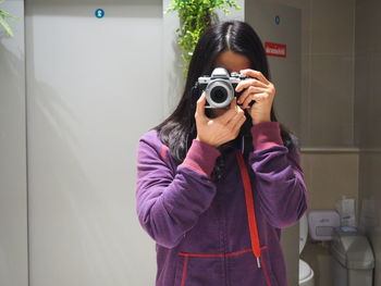 Portrait of woman photographing