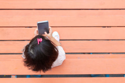 Rear view of woman using mobile phone