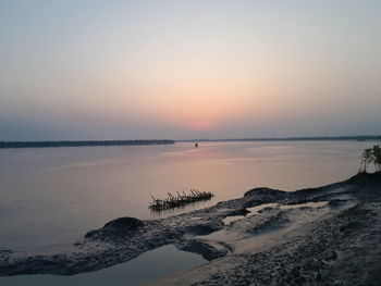 Scenic view of sea against clear sky during sunset