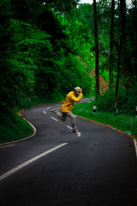 Rear view of man walking on road