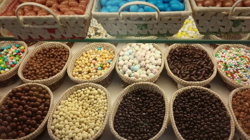 High angle view of candies in containers for sale at market