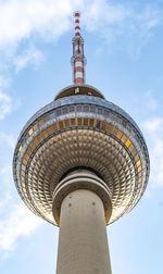 Low angle view of communications tower against sky